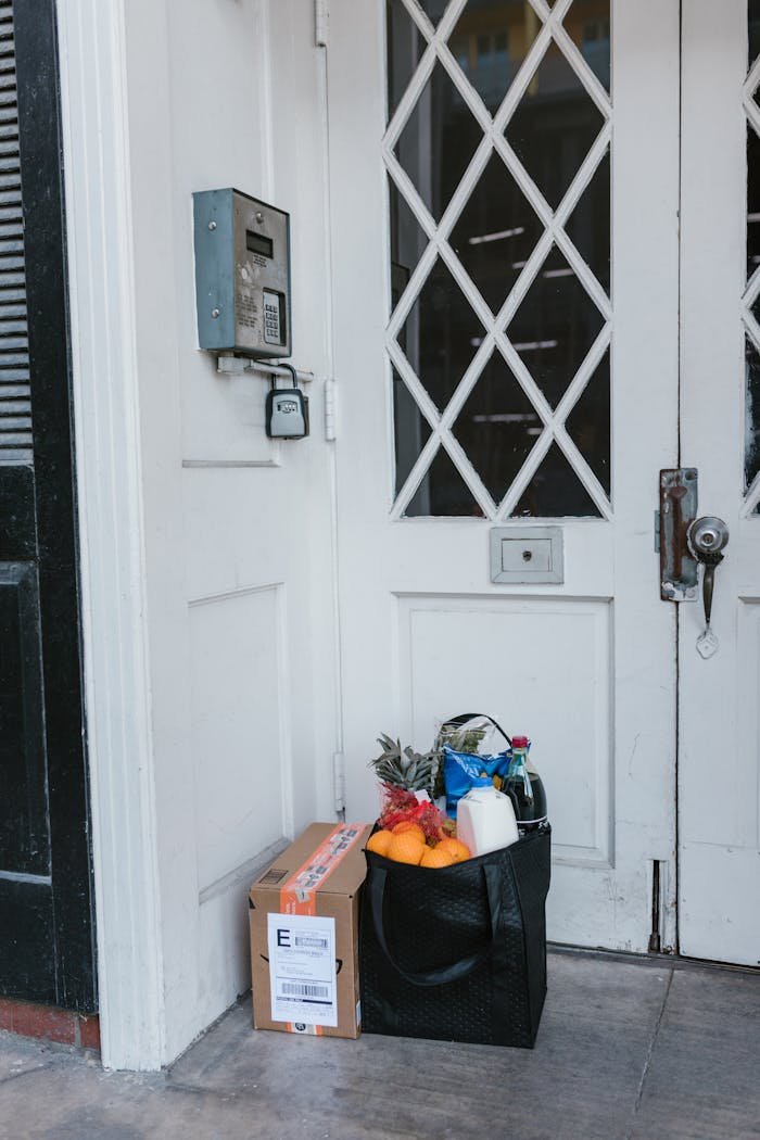 Grocery and package delivery left at a residential door during the pandemic.